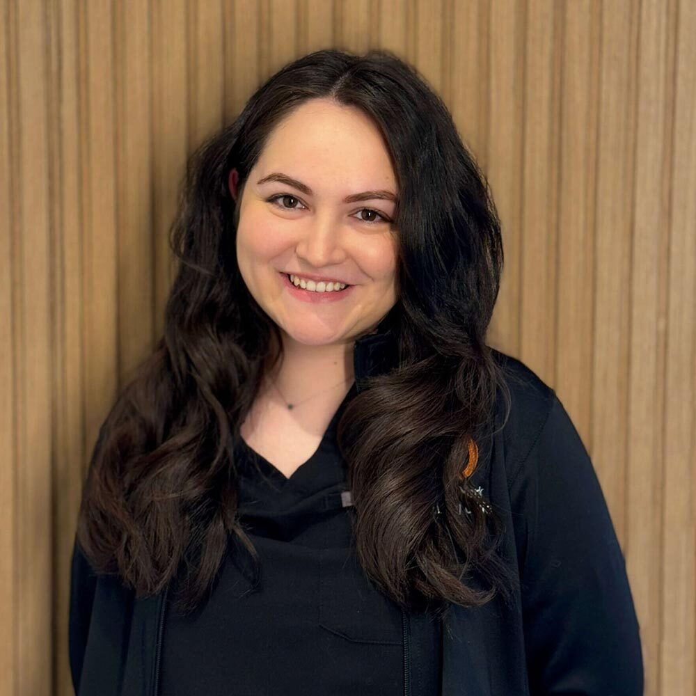 Jessica posing against a wood panel background