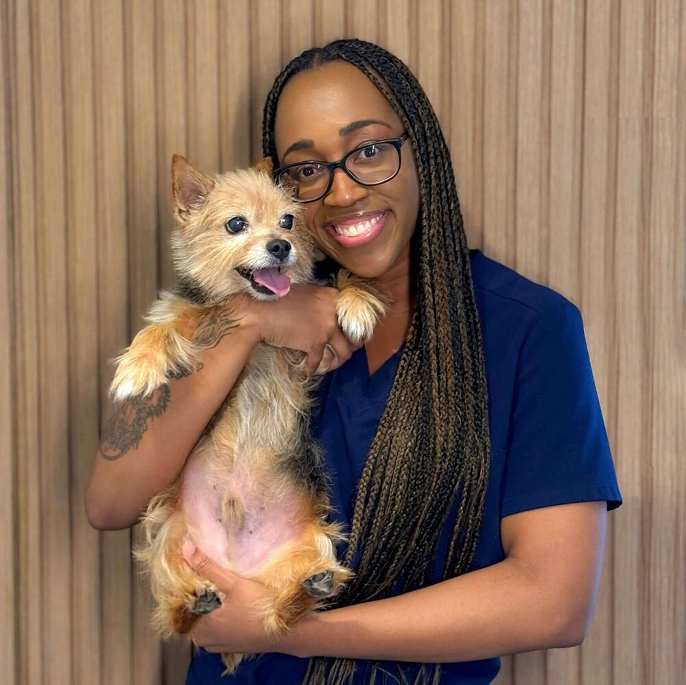 Shianne with her dog posing against a wood panel background